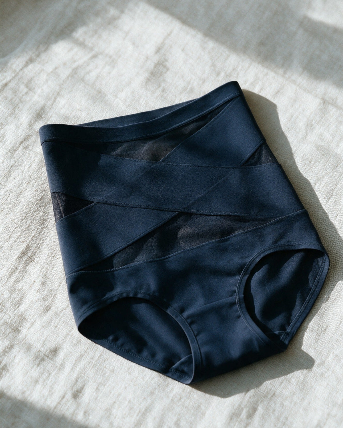 Haven Postpartum Support Brief in Navy, laid on linen