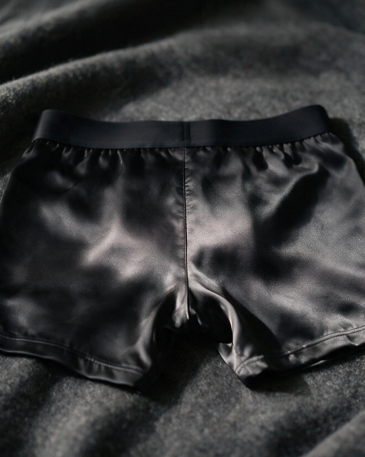 Mayfair men's silk-blend boxer in Black, back view of the satin in low light