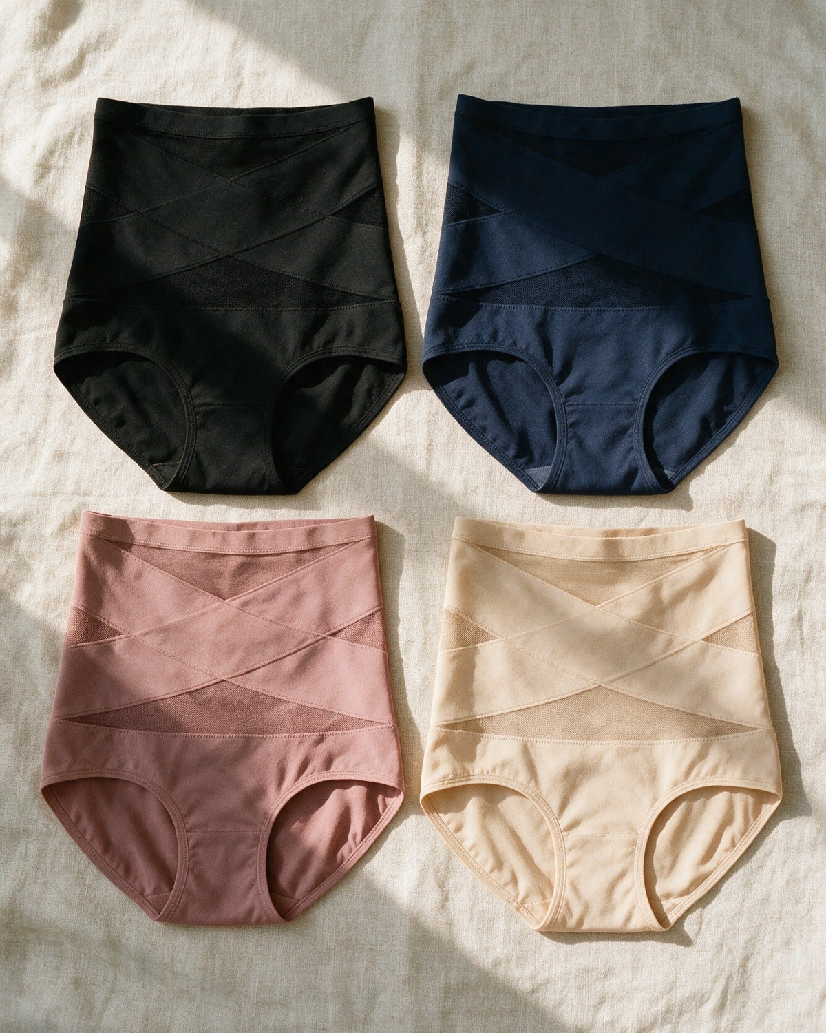 Haven Postpartum Support Brief in Black, Navy, Dusty Rose and Nude, laid flat on linen