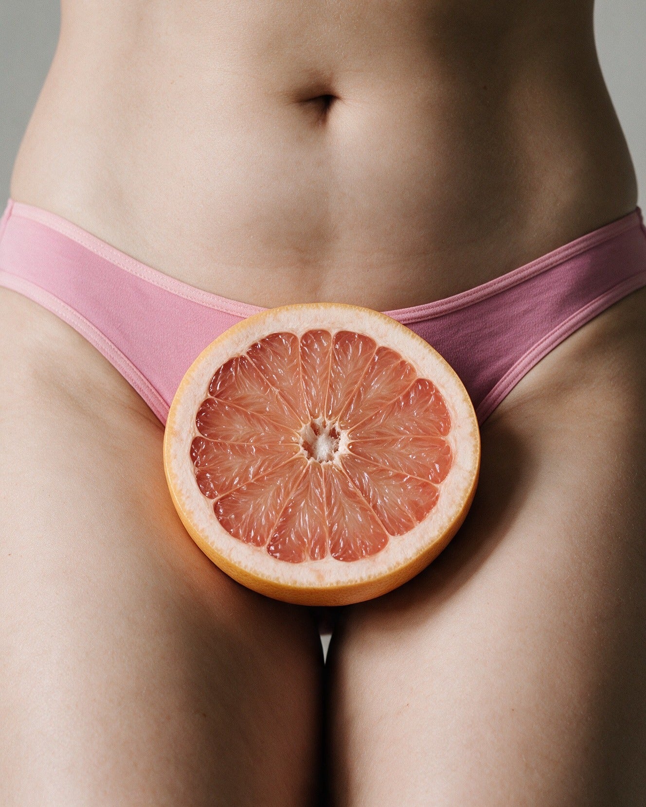 Elodie women's bamboo bikini brief in Pink with a halved grapefruit