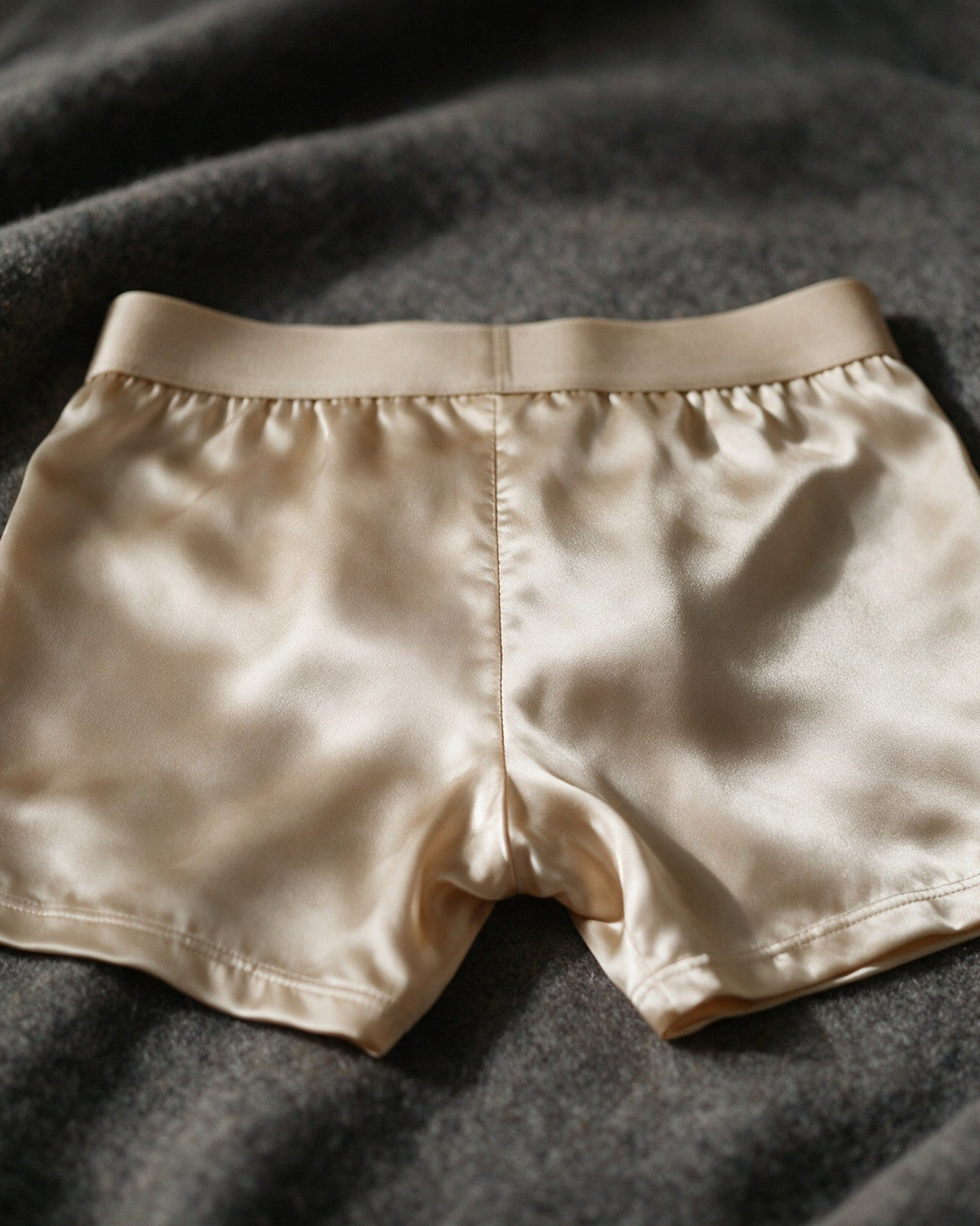 Mayfair men's silk-blend boxer in Champagne, back view of the satin in low light